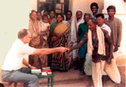 Staines giving alms to leprosy patients